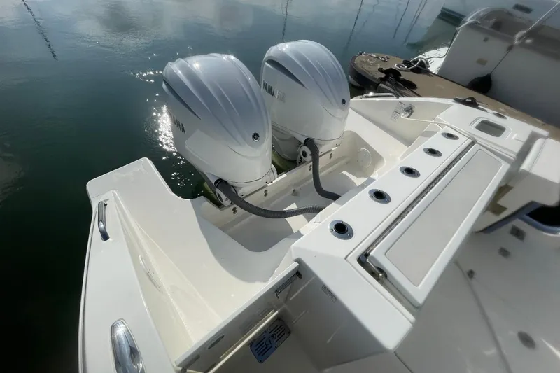 Slide: The Image of 2021 Pursuit S 328 Sport boat with dual Yamaha outboard engines on calm water. - 37