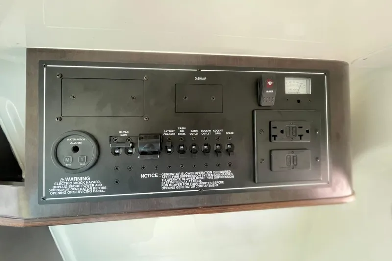 Slide: The Image of Control panel of a 2021 Pursuit S 328 Sport boat with various switches and outlets. - 42
