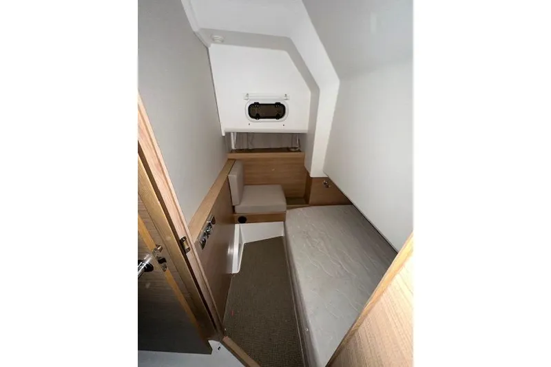 Slide: The Image of 2023 Nimbus C11 cabin interior with modern wood finish and compact design. - 11