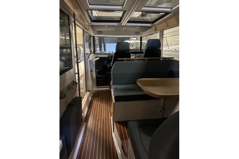 Slide: The Image of Interior of 2023 Nimbus C11 boat with seating and wooden flooring. - 17