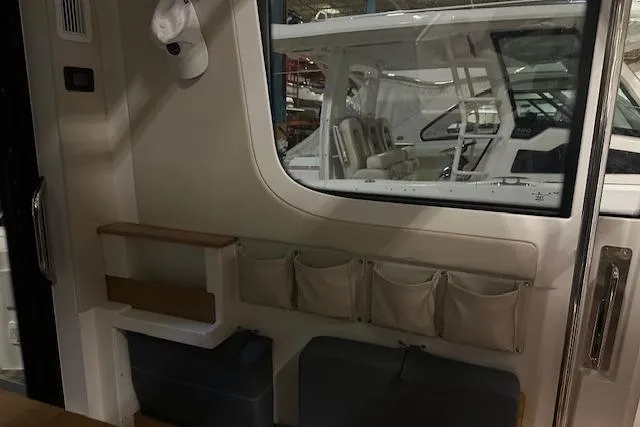 Slide: The Image of Interior of 2023 Nimbus C11 boat with storage pouches and seating area. - 19