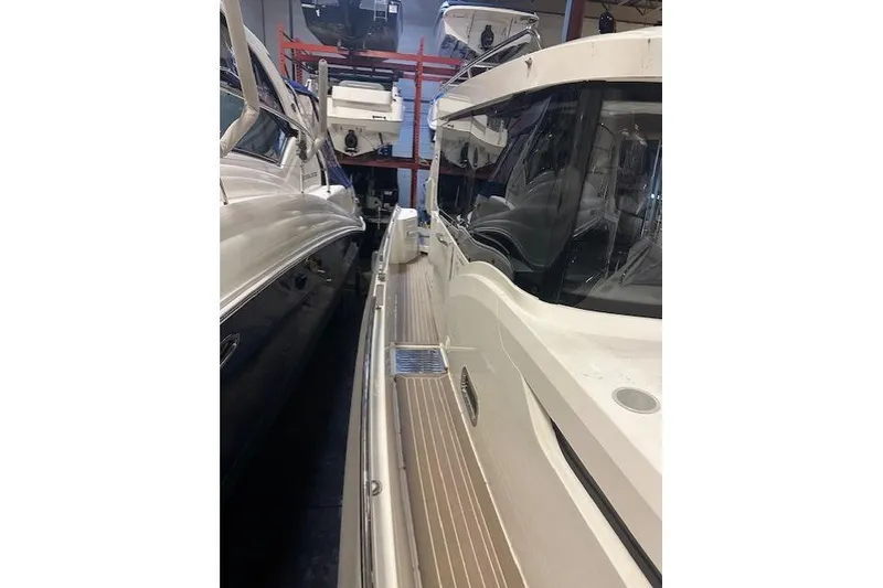 Slide: The Image of 2023 Nimbus C11 boat in storage, showcasing sleek design and modern features. - 22