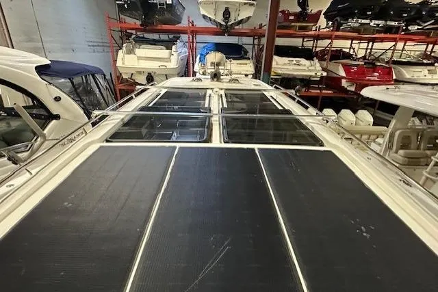 Slide: The Image of 2023 Nimbus C11 boat with solar panels, stored indoors among other boats. - 24