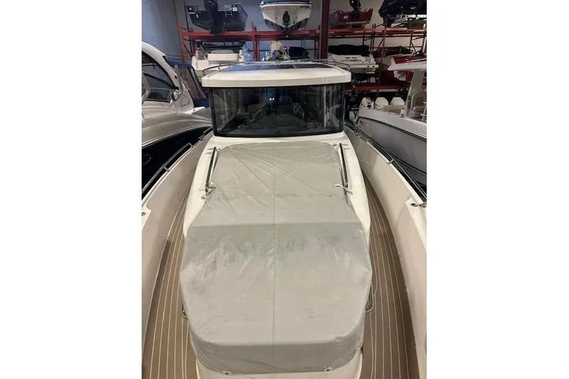 Slide: The Image of 2023 Nimbus C11 boat with covered deck in indoor storage. - 25