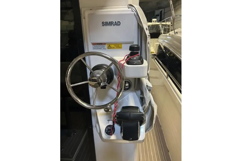 Slide: The Image of Steering console of 2023 Nimbus C11 boat with Simrad equipment. - 26