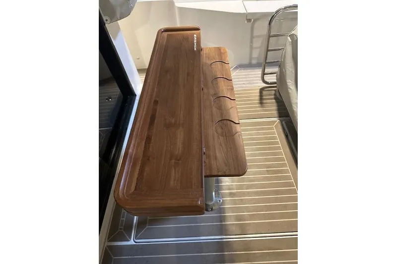 Slide: The Image of Wooden table on 2023 Nimbus C11 boat deck, featuring cup holders and sleek design. - 29
