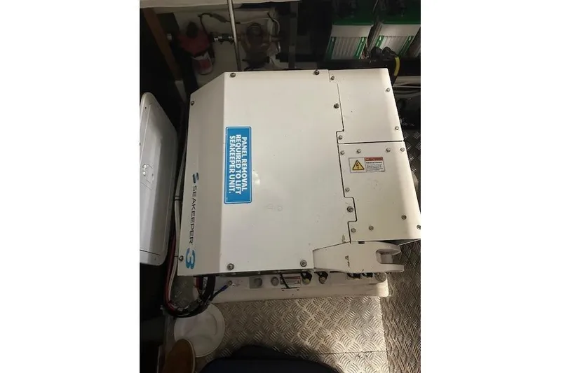 Slide: The Image of Engine compartment of a 2023 Nimbus C11 featuring a Seakeeper 3 stabilizer unit. - 6