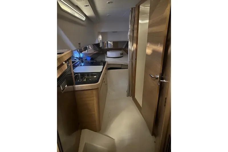 Slide: The Image of Luxurious interior of 2023 Nimbus C11 yacht with modern kitchen and cozy sleeping area. - 7
