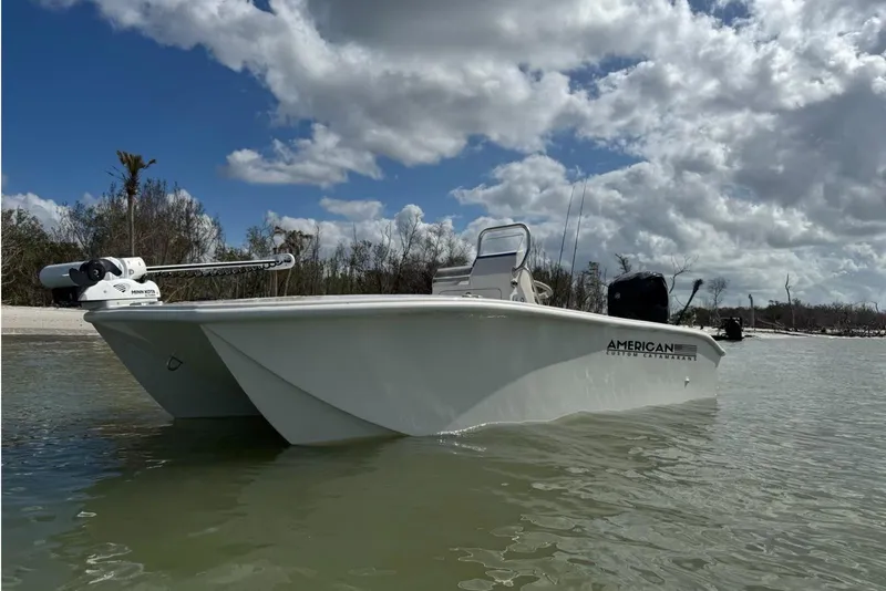 The Image of 2026 American Custom Catamarans 17LF boat on calm water under cloudy sky. - 1