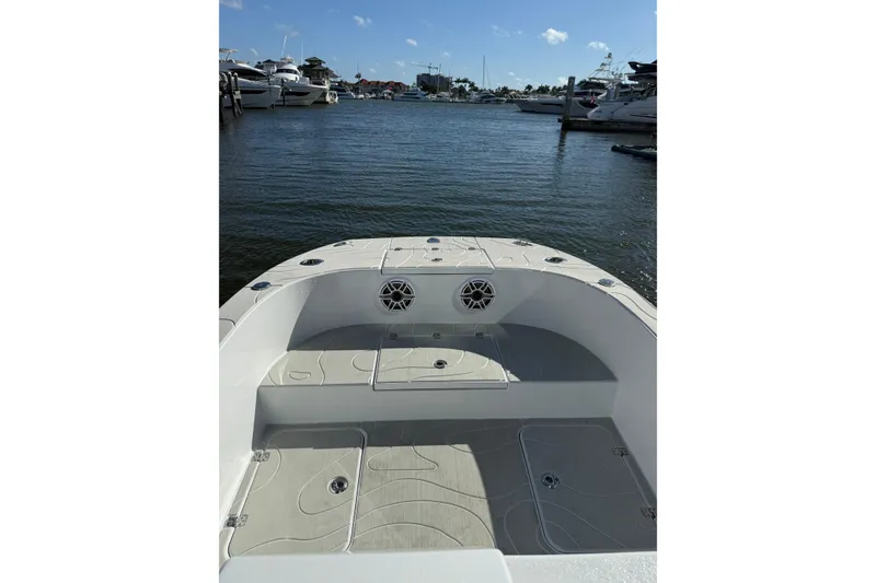 Slide: The Image of 2026 American Custom Catamarans 17 at marina, showcasing spacious deck and seating area. - 11