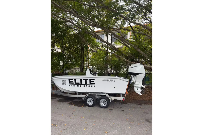 Slide: The Image of 2026 American Custom Catamarans 17 on trailer, Elite Marine Group branding, Honda outboard motor. - 7