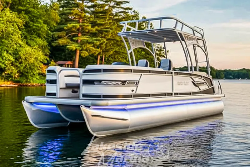 Slide: The Image of 2023 Godfrey AquaPatio 255 SDC pontoon boat on a serene lake. - 0
