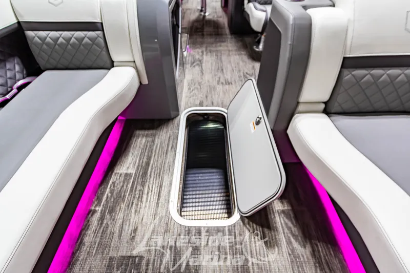 Slide: The Image of Interior of 2023 Godfrey AquaPatio 255 SDC with open storage compartment and LED lighting. - 22