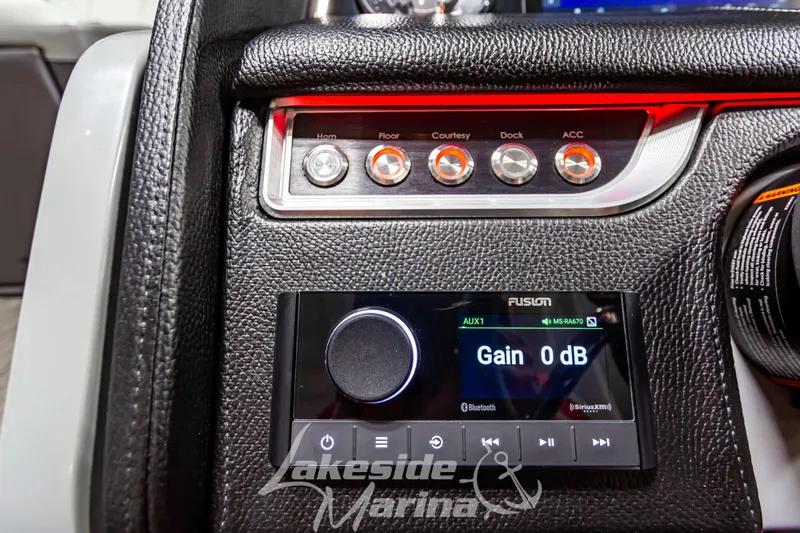 Slide: The Image of Control panel of the 2023 Godfrey AquaPatio 255 SDC boat with audio system. - 29