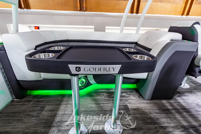 Slide: The Image of 2023 Godfrey AquaPatio 255 SDC interior with table and cup holders. - 32