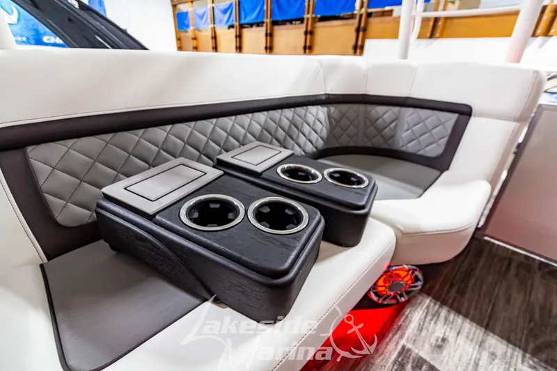 Slide: The Image of Luxurious seating on the 2023 Godfrey AquaPatio 255 SDC with cup holders and quilted upholstery. - 33