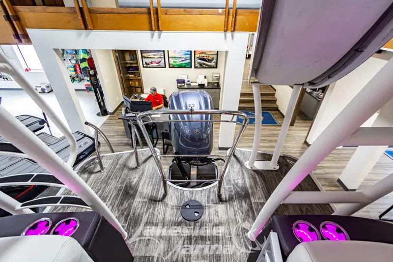 Slide: The Image of 2023 Godfrey AquaPatio 255 SDC boat interior with modern design and purple LED cup holders. - 38