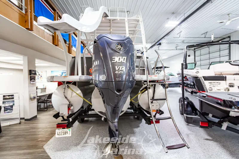Slide: The Image of 2023 Godfrey AquaPatio 255 SDC pontoon boat with 300 V8 engine in showroom. - 4