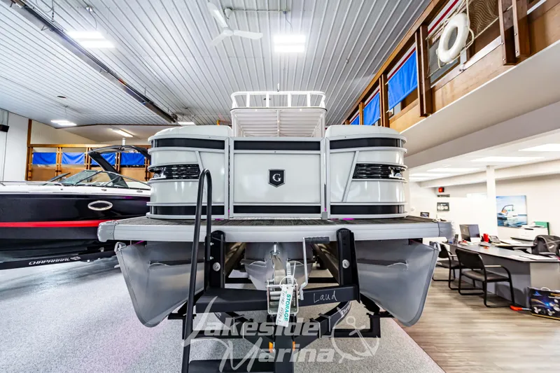 Slide: The Image of 2023 Godfrey AquaPatio 255 SDC pontoon boat displayed indoors. - 7