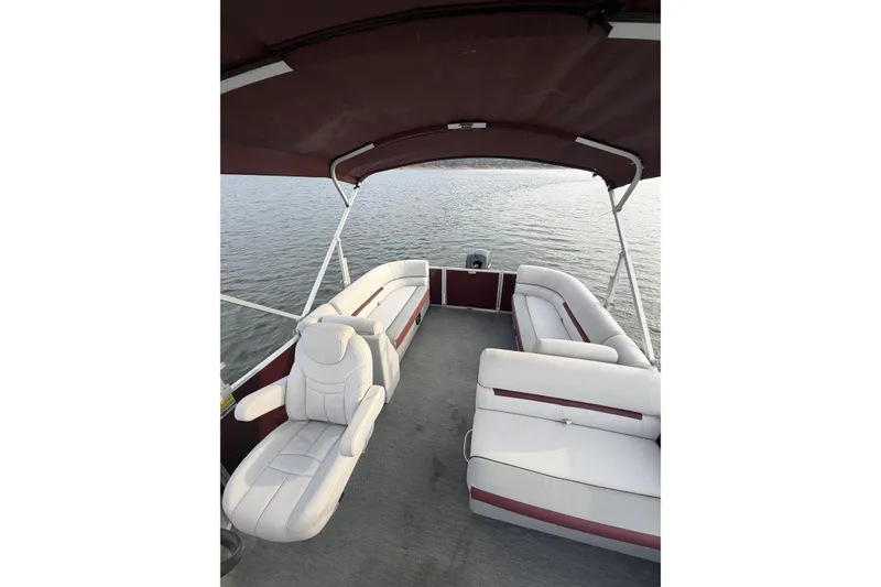 Slide: The Image of 2023 Godfrey Sweetwater 2286 C pontoon boat interior with white seating and canopy. - 12
