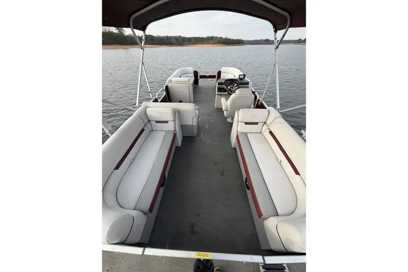 Slide: The Image of 2023 Godfrey Sweetwater 2286 C pontoon boat interior on a calm lake. - 13
