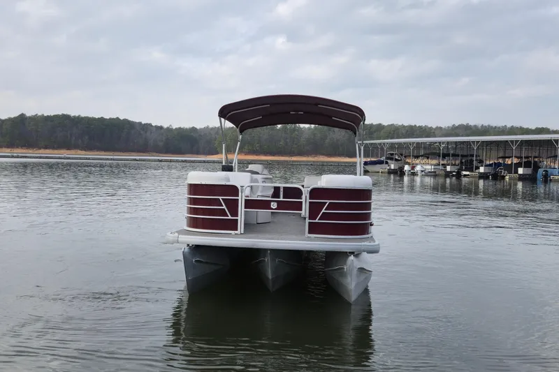 Slide: The Image of 2023 Godfrey Sweetwater 2286 C pontoon boat on a calm lake. - 7