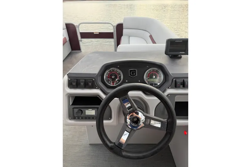 Slide: The Image of Steering console of 2023 Godfrey Sweetwater 2286 C pontoon boat, featuring gauges and controls. - 8