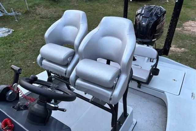 Slide: The Image of 2025 Freedom Boats 23' Warrior with dual seats and steering console, outdoor setting. - 10