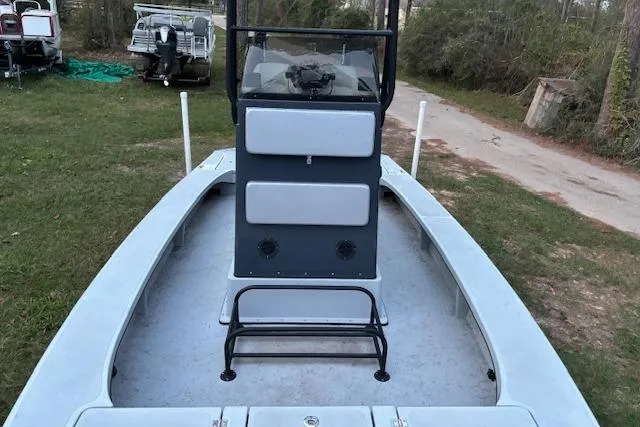 Slide: The Image of 2025 Freedom Boats 23' Warrior, center console, parked on grass, showcasing spacious deck. - 12