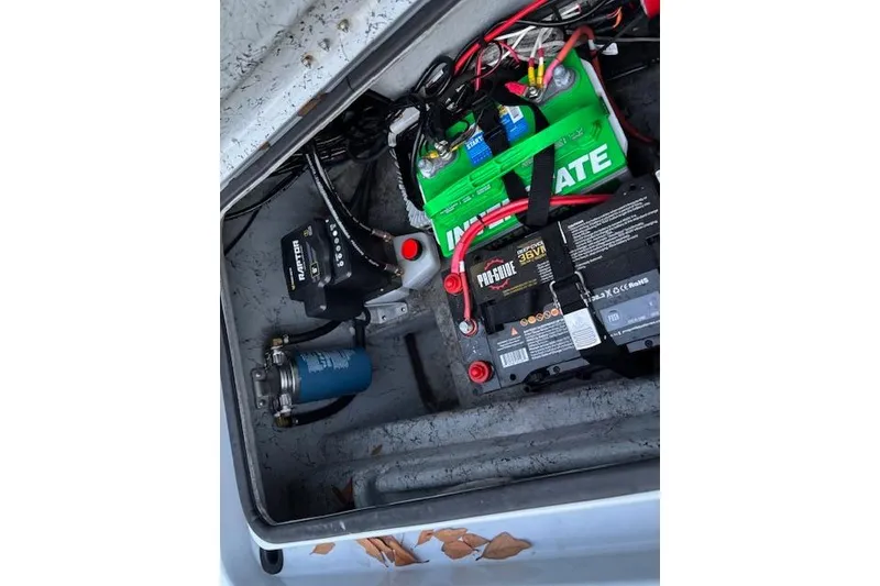 Slide: The Image of Battery compartment of 2025 Freedom Boats 23' Warrior, featuring Interstate and Pro-Guide batteries. - 13