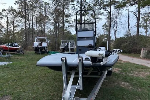 Slide: The Image of 2025 Freedom Boats 23' Warrior on trailer in wooded area. - 7