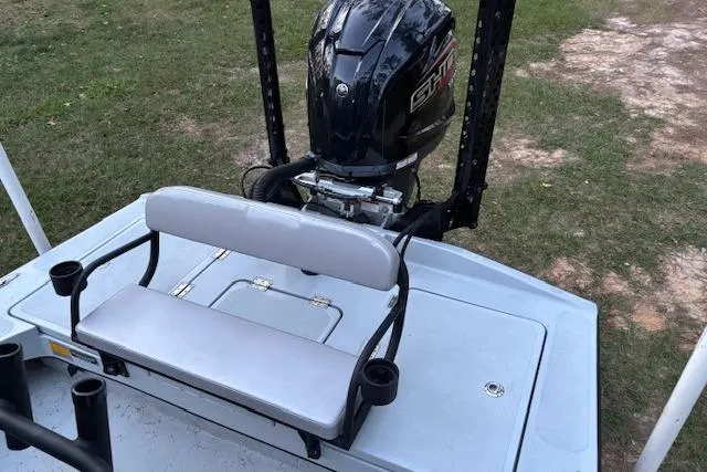 Slide: The Image of 2025 Freedom Boats 23' Warrior with outboard motor and seating, on grassy area. - 9