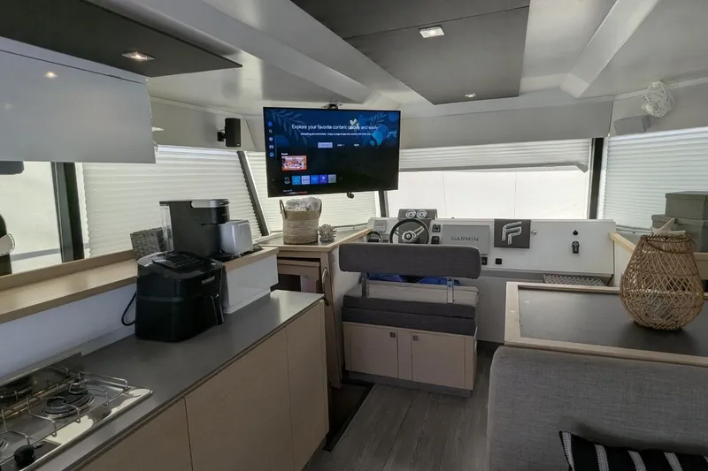 Slide: The Image of Modern interior of 2020 Fountaine Pajot MY 37 yacht with helm, TV, and kitchen area. - 10