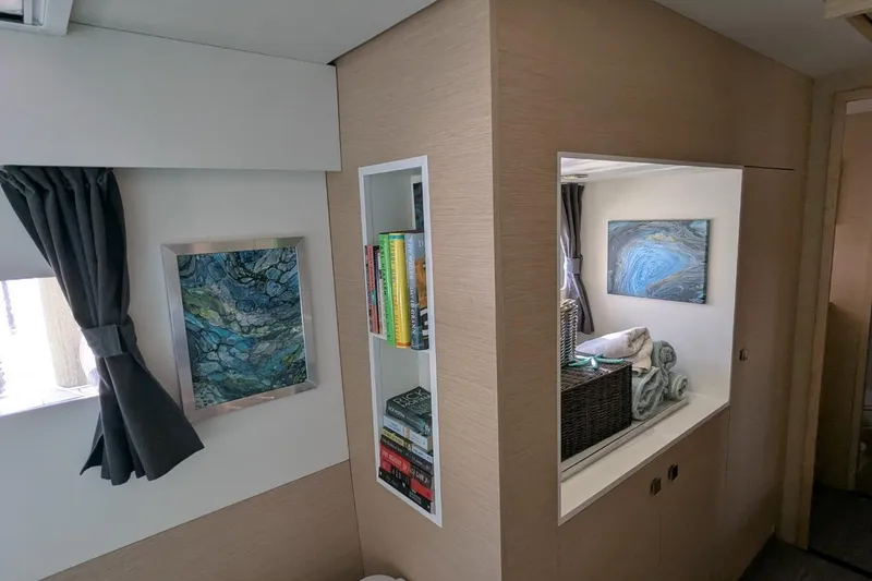 Slide: The Image of Interior of 2020 Fountaine Pajot MY 37 yacht with modern decor and bookshelf. - 16