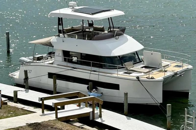 Slide: The Image of 2020 Fountaine Pajot MY 37 yacht docked at a marina, featuring modern design and spacious deck. - 2