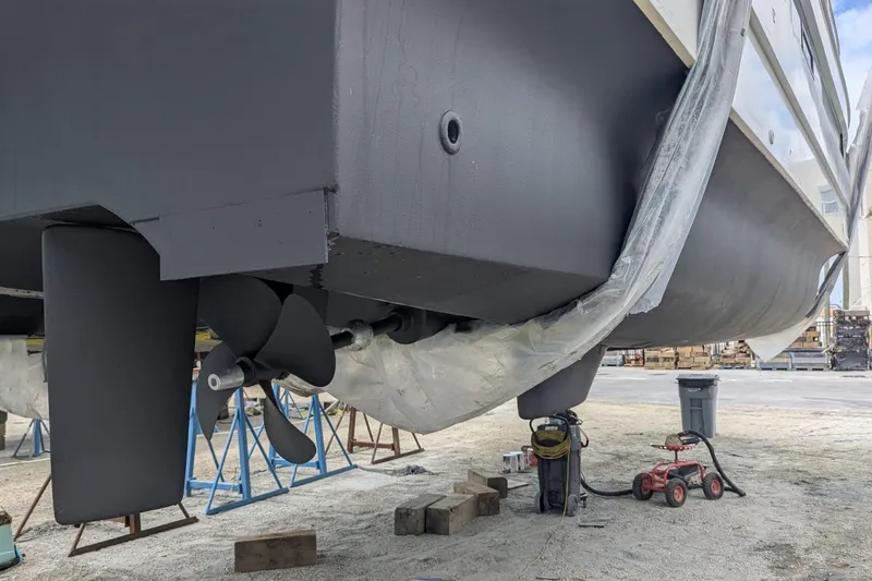 Slide: The Image of 2020 Fountaine Pajot MY 37 yacht under maintenance, showing propeller and hull details. - 27