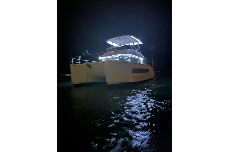 Slide: The Image of 2020 Fountaine Pajot MY 37 yacht illuminated at night on the water. - 4