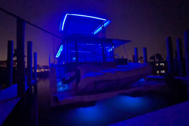 Slide: The Image of 2020 Fountaine Pajot MY 37 yacht illuminated with blue lights at night. - 6