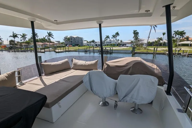 Slide: The Image of 2020 Fountaine Pajot MY 37 yacht deck with seating, overlooking a serene waterfront view. - 7