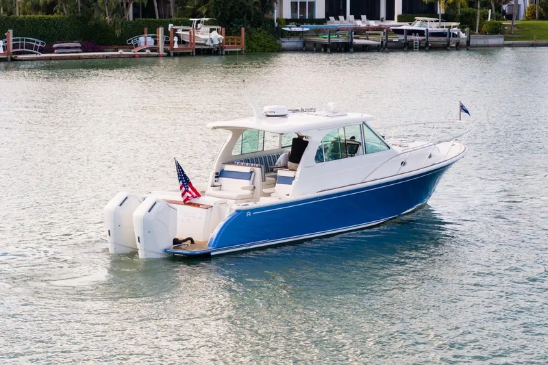 Slide: The Image of 2025 Hinckley Sport Boat 40 X cruising on calm waters, showcasing sleek design and dual engines. - 1