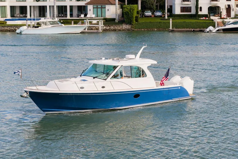 The Image of 2025 Hinckley Sport Boat 40 X cruising on a scenic waterway. - 0