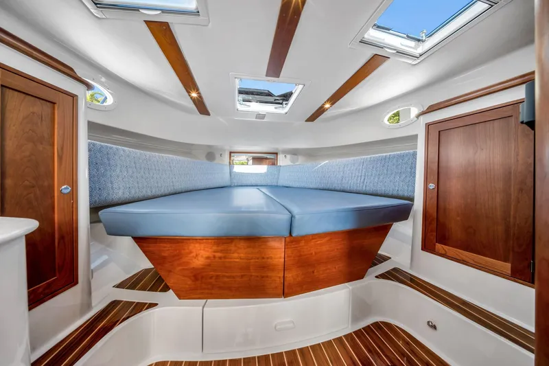 Slide: The Image of Luxurious interior of 2025 Hinckley Sport Boat 40 X with wood accents and skylights. - 11