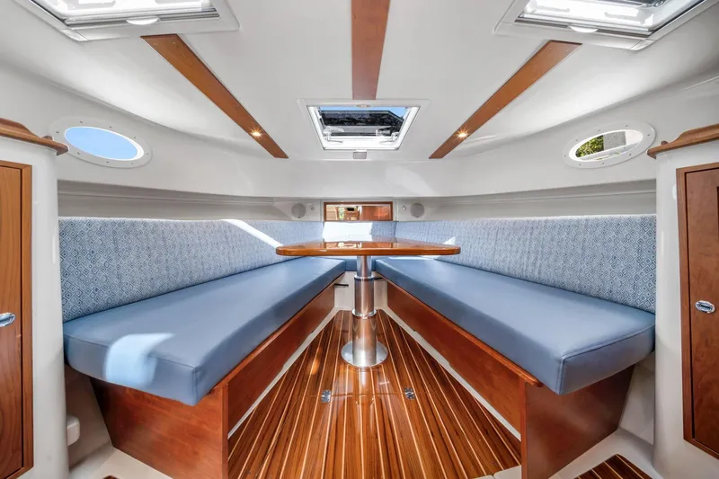 Slide: The Image of Luxurious interior of 2025 Hinckley Sport Boat 40 X with elegant seating and wooden finishes. - 9
