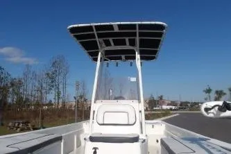 Slide: The Image of 2018 H20 Sports MFG 21 V/CC boat with T-top, clear sky background. - 10