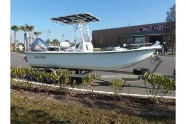 Slide: The Image of 2018 H20 Sports MFG 21 V/CC boat on trailer, parked near a service center. - 4
