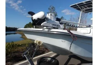 Slide: The Image of 2018 H20 Sports MFG 21 V/CC boat with Minn Kota trolling motor by a lake. - 9