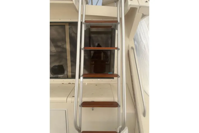 Slide: The Image of Staircase on 1988 Viking 35 Convertible yacht with wooden steps and metal railings. - 12