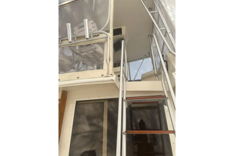 Slide: The Image of 1988 Viking 35 Convertible boat with ladder to upper deck and enclosed cockpit. - 13