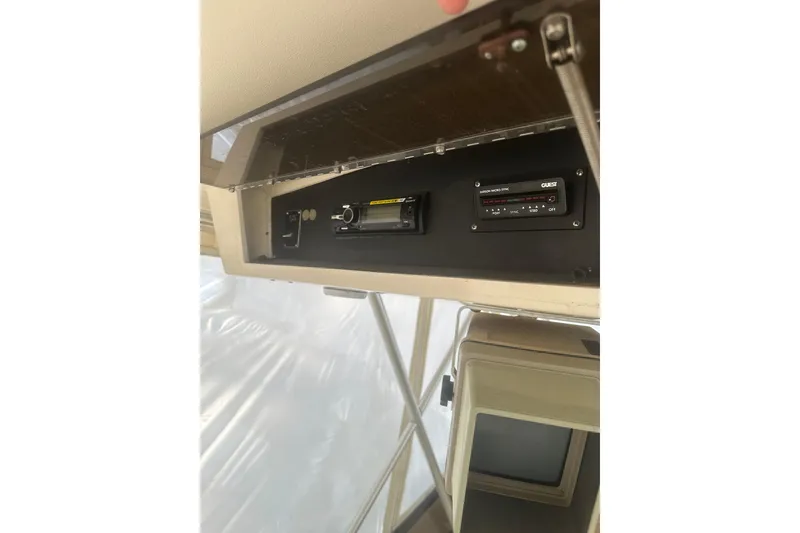 Slide: The Image of 1988 Viking 35 Convertible boat dashboard with electronic controls and display. - 14