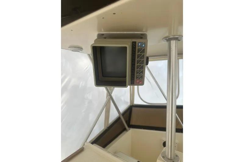 Slide: The Image of 1988 Viking 35 Convertible boat interior with vintage electronic display. - 15